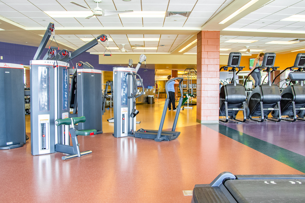 A photo of a cluster of treadmills and other workout equipment.