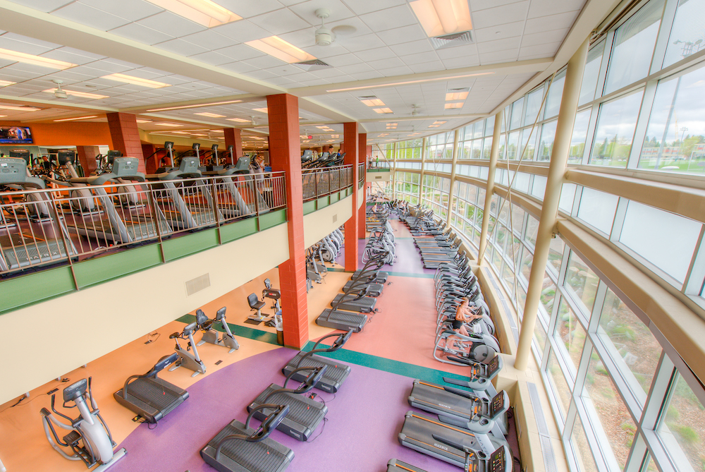 A photo of our upstairs and downstairs workout facility with treadmills and other various workout machines.