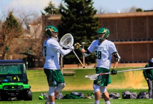 Photo of two lacrosse participants congratulating each other after a play.