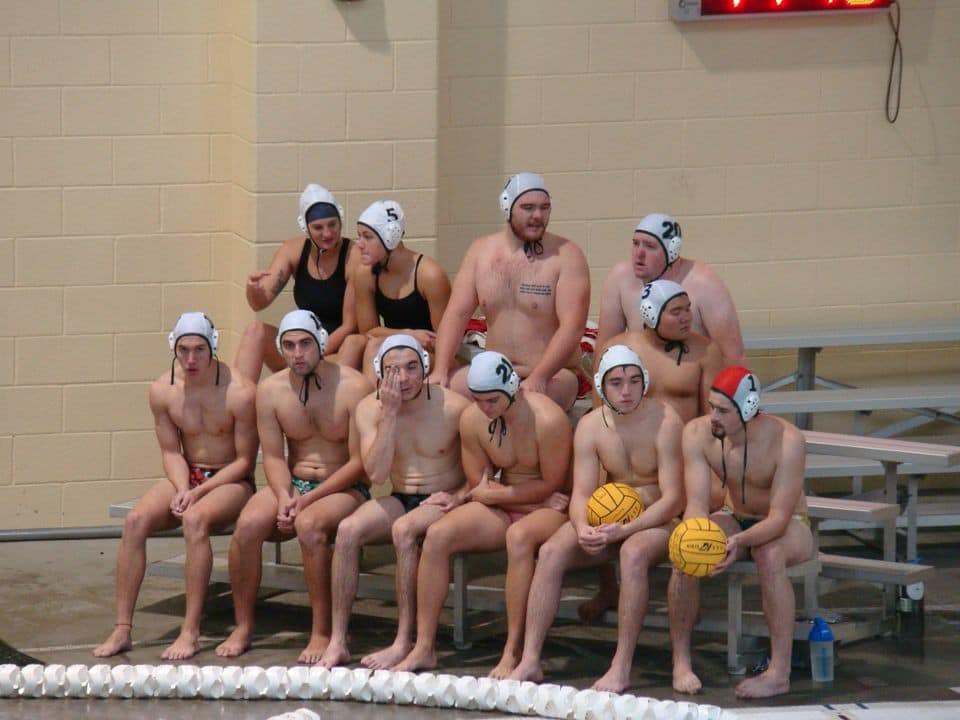 Photo of waterpolo participants sitting on bleachers.